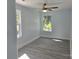 Cozy bedroom featuring gray vinyl floors, ceiling fan, and two large windows with natural light at 245 College E Ave, Shelby, NC 28152