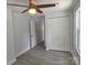 Bedroom with gray vinyl floors, ceiling fan, closet, and a window providing natural light at 245 College E Ave, Shelby, NC 28152