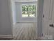 Cozy bedroom featuring a large window that provides great natural lighting and new floors at 245 College E Ave, Shelby, NC 28152