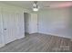 Bright bedroom with ceiling fan, new gray flooring, and multiple closets for ample storage at 245 College E Ave, Shelby, NC 28152