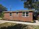 Side view of brick home with a new concrete sidewalk and colorful landscaping at 245 College E Ave, Shelby, NC 28152