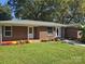 Well-maintained brick home with colorful landscaping, flowers and green lawn at 245 College E Ave, Shelby, NC 28152