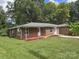 Charming brick home with lush green lawn and colorful flower beds at 245 College E Ave, Shelby, NC 28152