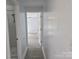 Hallway with gray vinyl floors leading into a bedroom, showcasing the home's open layout at 245 College E Ave, Shelby, NC 28152