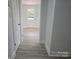 Hallway featuring new flooring and fresh paint, leading to other rooms in the home at 245 College E Ave, Shelby, NC 28152