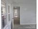 Hallway with new floors, connecting the house, leads to an outside door and has plenty of lighting at 245 College E Ave, Shelby, NC 28152
