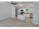 Bright kitchen with white cabinets, granite countertops, stainless steel appliances, and an island at 245 College E Ave, Shelby, NC 28152