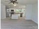 Open concept kitchen with new stainless steel appliances and gray laminate flooring at 245 College E Ave, Shelby, NC 28152