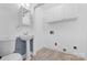 Bathroom with pedestal sink, toilet, overhead cabinets, and light-colored wood-look flooring at 262 Vermont Dr, Stanley, NC 28164