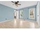 Bedroom with light wood-look flooring, light blue walls, two large windows, and ceiling fan at 262 Vermont Dr, Stanley, NC 28164