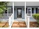 Inviting front porch with brick steps, white railings, and black-framed glass door at 262 Vermont Dr, Stanley, NC 28164