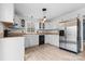 Bright kitchen featuring stainless steel refrigerator, black dishwasher, and white cabinets at 262 Vermont Dr, Stanley, NC 28164