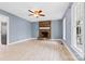 Bright living room with wood-burning stone fireplace, light hardwood floors, and plenty of natural light at 262 Vermont Dr, Stanley, NC 28164