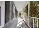 Charming covered porch with gray wood shingle siding and classic white railings at 262 Vermont Dr, Stanley, NC 28164