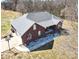 Aerial view of the brick home, attached garage, and long driveway at 28926 Hartsell Rd, Albemarle, NC 28001
