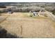 Expansive aerial view of the property with fields, woods, home, and barn at 28926 Hartsell Rd, Albemarle, NC 28001