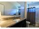 Bathroom showcasing a granite vanity top with black cabinets and shower with tub at 28926 Hartsell Rd, Albemarle, NC 28001