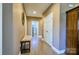 Hallway featuring tan walls, wood flooring, and bench seating for functionality at 28926 Hartsell Rd, Albemarle, NC 28001