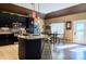 Well-lit kitchen with stainless steel appliances, granite countertops, black cabinets and a dining area at 28926 Hartsell Rd, Albemarle, NC 28001