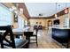 Open-concept living space with dining area, kitchen, and a comfortable seating area with leather sofas at 28926 Hartsell Rd, Albemarle, NC 28001