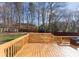 Inviting wooden deck with built-in bench seating, ideal for enjoying the backyard view at 3017 Laurelwood Dr, Matthews, NC 28105