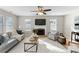 Bright living room features a fireplace, neutral paint, a ceiling fan, and lots of natural light at 3017 Laurelwood Dr, Matthews, NC 28105