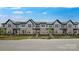 Modern townhome exterior showcasing brick and neutral siding, black trim, lush landscaping, and inviting curb appeal at 3105 Beacon Heights Rd, Indian Land, SC 29707