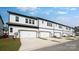 Modern townhome exterior with white siding, attached garages, and well-maintained landscaping at 3105 Beacon Heights Rd, Indian Land, SC 29707