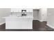Stylish kitchen featuring a large island, white cabinets, modern appliances, and sleek dark wood flooring at 3105 Beacon Heights Rd, Indian Land, SC 29707