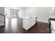 Open kitchen with a center island, stainless steel appliances, and sleek dark flooring blending into living space at 3105 Beacon Heights Rd, Indian Land, SC 29707