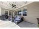 Relaxing outdoor living space with comfortable seating, ceiling fan, and string lights at 3113 Winged Teal Ct, Belmont, NC 28012