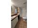 Bathroom with updated vanity, mirror, and walk-in shower with tiled flooring at 350 Brawley Rd, Cleveland, NC 27013