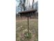 Rustic wooden birdhouse on a metal pole in a grassy backyard at 350 Brawley Rd, Cleveland, NC 27013