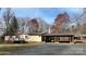 Ranch-style home with a covered carport and deck, nestled on a well-maintained lot with mature trees at 350 Brawley Rd, Cleveland, NC 27013