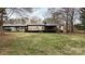 Rear exterior view showcasing a well-maintained home, covered parking, and a cozy deck at 350 Brawley Rd, Cleveland, NC 27013