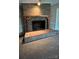 Close up of a brick fireplace with a wood mantel and a raised brick hearth at 350 Brawley Rd, Cleveland, NC 27013