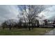 Spacious front yard featuring mature trees, a well maintained lawn, and a charming single-story house at 350 Brawley Rd, Cleveland, NC 27013