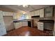 Functional kitchen with white cabinets, laminate countertops, and hardwood floors at 350 Brawley Rd, Cleveland, NC 27013