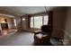 Comfortable living room with a large window, plush chair, and neutral color palette at 350 Brawley Rd, Cleveland, NC 27013