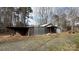 Exterior view of a storage shed, with an open bay, and a gravel driveway at 350 Brawley Rd, Cleveland, NC 27013