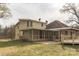 Backyard view of house featuring large porch and yard, and a two-story home at 3607 Austin Rd, Monroe, NC 28112