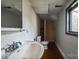 Bathroom featuring a sink, toilet, and shower in a compact layout with natural light at 3607 Austin Rd, Monroe, NC 28112