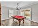 Game room with a pool table, modern lighting, and sliding glass doors leading to the outdoors at 3607 Austin Rd, Monroe, NC 28112