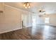 Open concept living room featuring hardwood floors, modern lighting, and shiplap walls at 3607 Austin Rd, Monroe, NC 28112