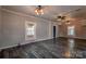 Cozy living area with dark wood flooring and ample natural light from the windows at 3607 Austin Rd, Monroe, NC 28112
