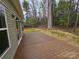 A spacious wooden back deck overlooks a lovely backyard full of mature trees at 3667 Travertine Dr, Lancaster, SC 29720
