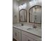 Elegant bathroom featuring double sinks with granite countertops, decorative mirrors, and modern fixtures at 3667 Travertine Dr, Lancaster, SC 29720