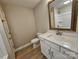 Bathroom with a framed mirror, white cabinets, hard surface countertops and flooring at 3667 Travertine Dr, Lancaster, SC 29720