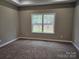Neutral bedroom with large window, ceiling fan, and plush carpeting at 3667 Travertine Dr, Lancaster, SC 29720