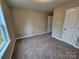 Cozy bedroom with neutral walls, plush carpet, and a bright window with a view at 3667 Travertine Dr, Lancaster, SC 29720
